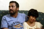 Iranians Mohammad Hardani, 36, and his daughter Athena Hardani, 10, are reunited at a hotel in Juanda, Indonesia on December 23rd, 2011 after surviving the sinking of an Australia-bound people-smuggling boat five days earlier. At least 90 migrants died in the incident. Indonesia and Malaysia recently cancelled visa-on-arrival policies for Iranians to stem people- and drug-smuggling, authorities say. [Juni Kriswanto/AFP]